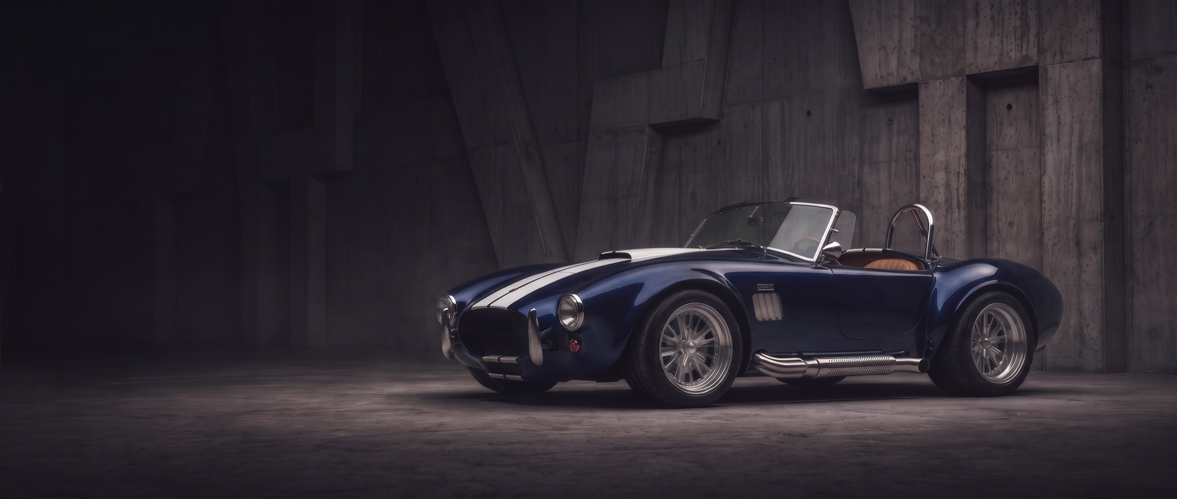 A navy Cobra roadster with white stripes and polished side pipes in a concrete hall
